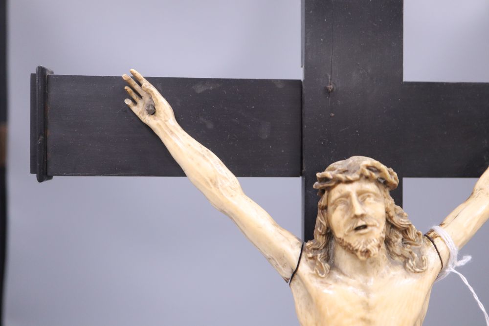 A carved ivory and ebony crucifix, height 59cm